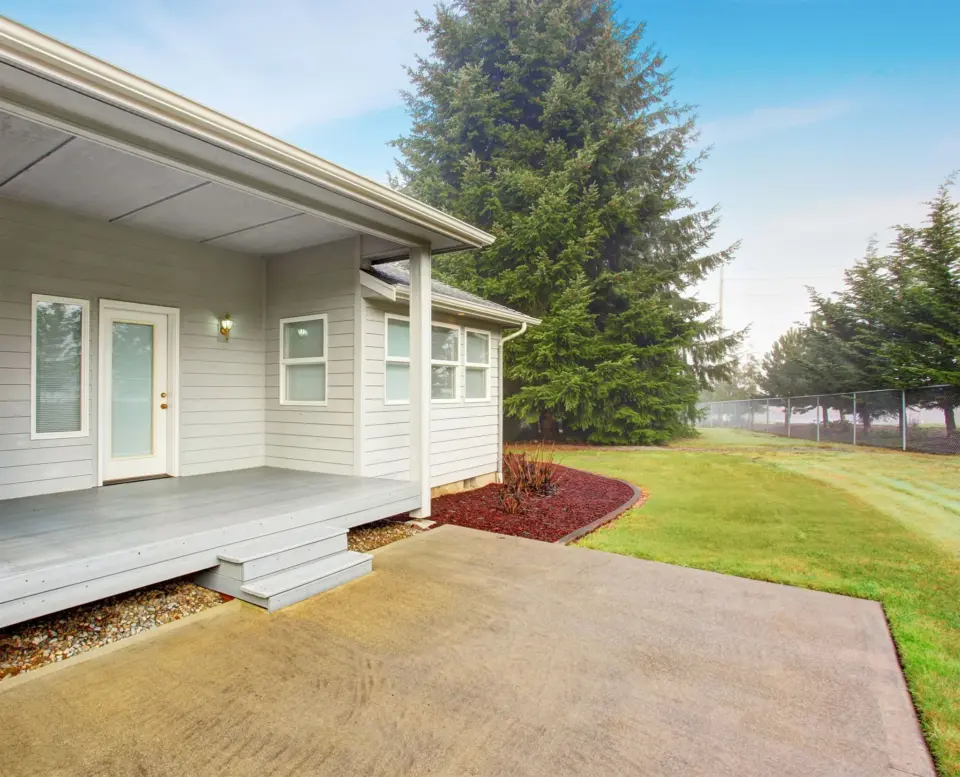 backyard-with-wood-porch-and-patio-with-big-tree-on-the-background-in-lincoln-ne