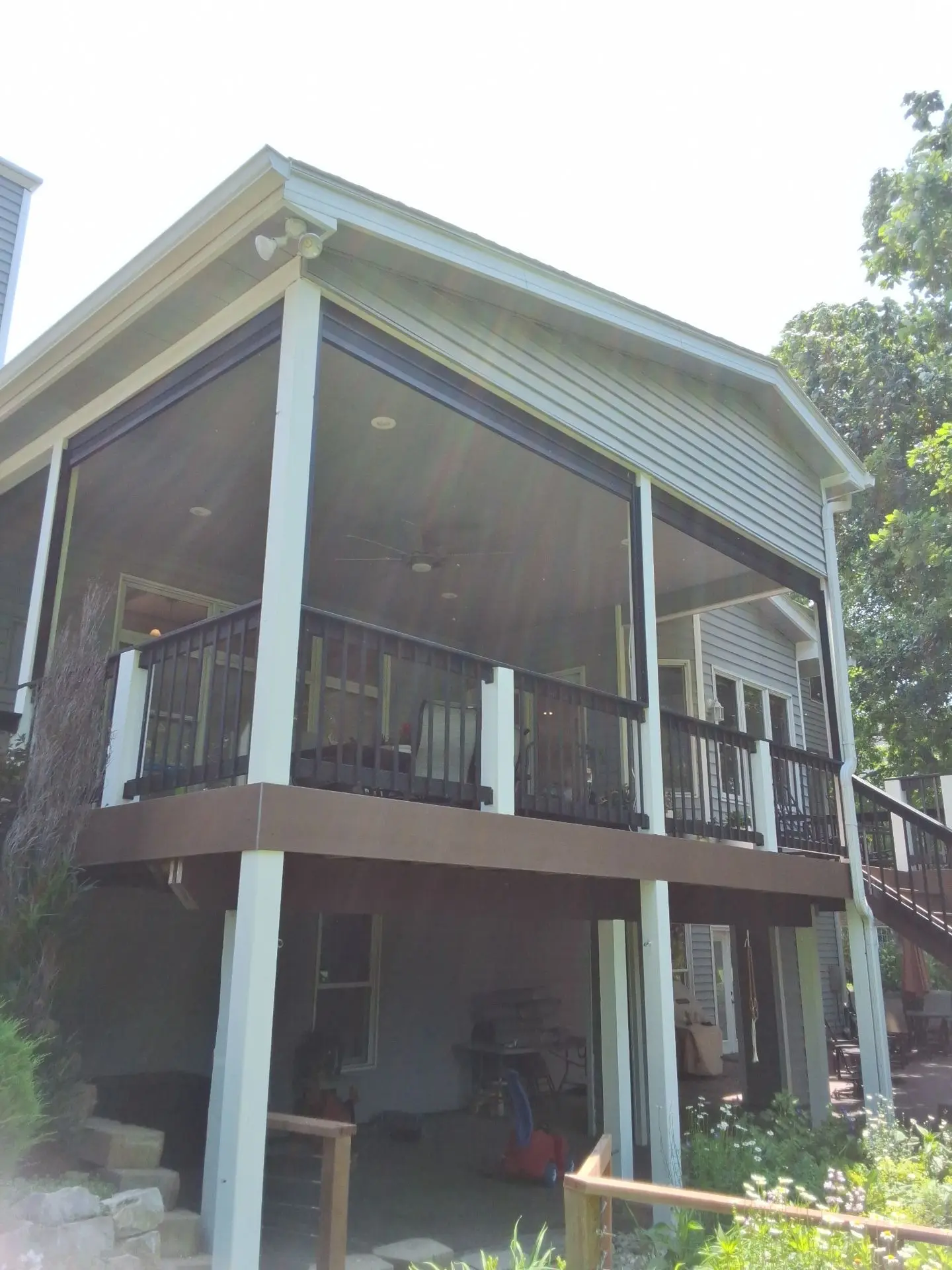 covered-elevated-deck-with-black-metal-railing-and-a-screened-in-porches-in-lincoln-ne