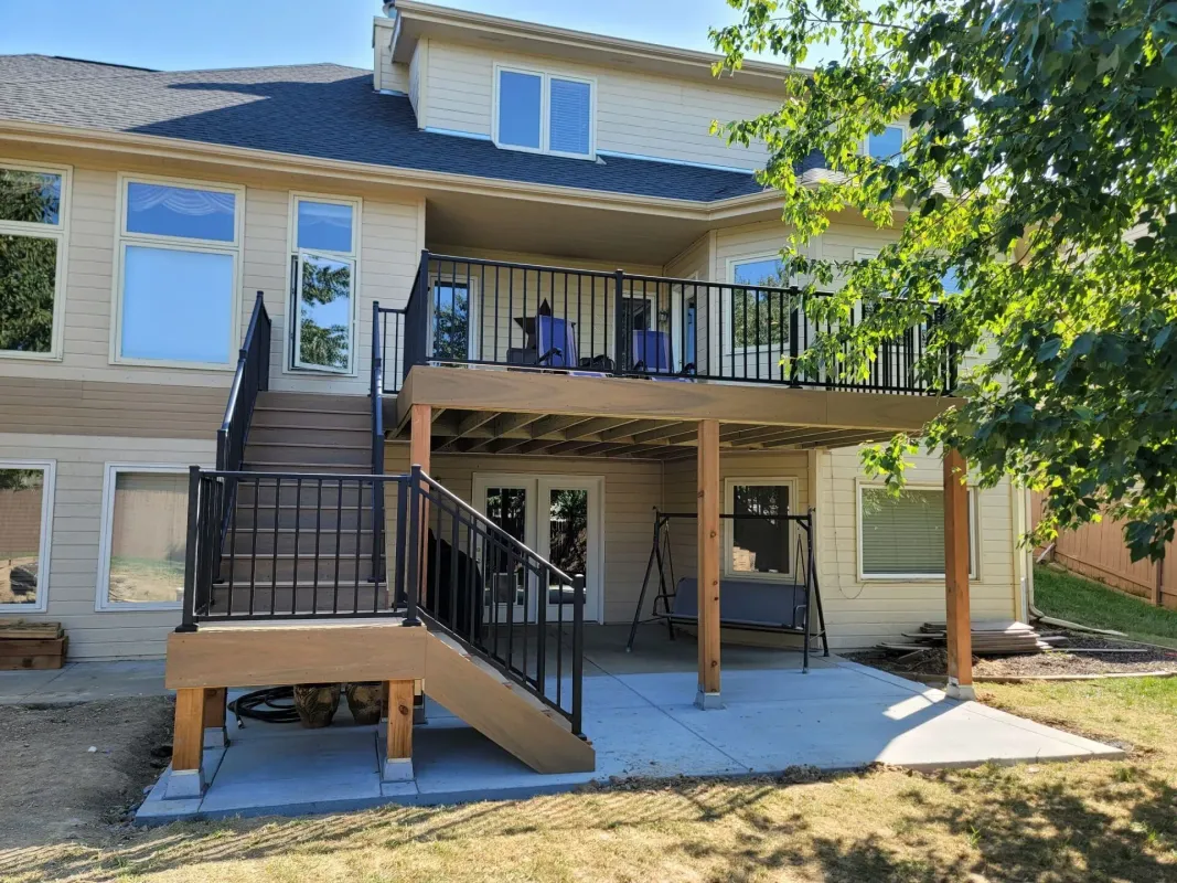 elevated-residential-deck-with-black-metal-railing-and-outdoor-furniture-in-black-label-built