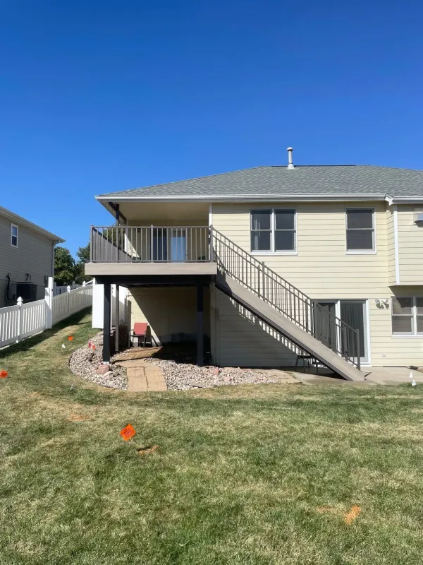 front-view-of-the-residential-ddeck-with-railing-and-white-fence-on-the-backyard-in-lincoln-ne