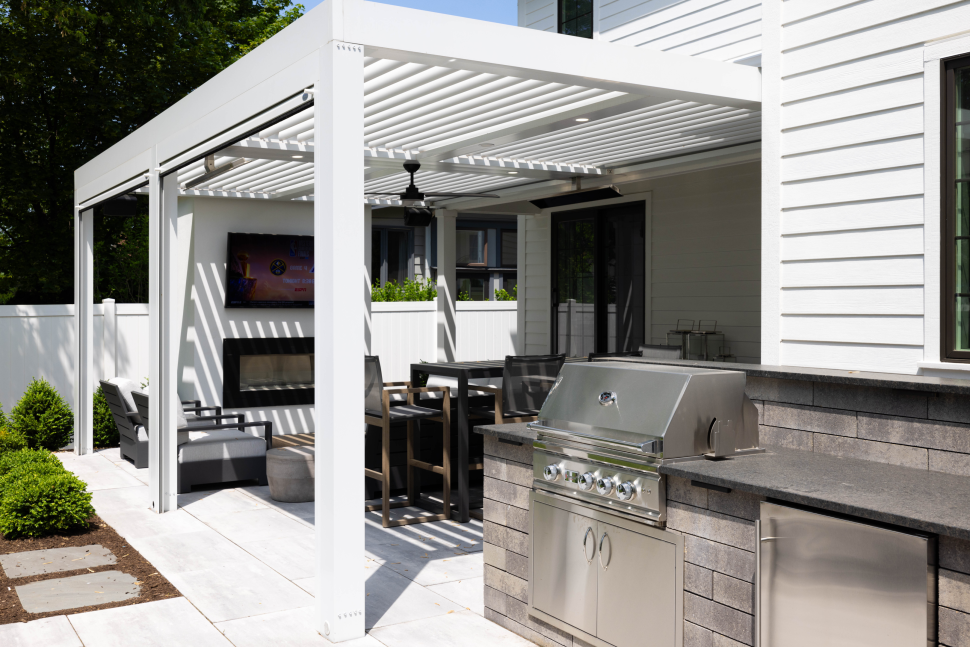 louvered-pergola-with-outdoor-kitchen-and-fireplace-in-lincoln-ne