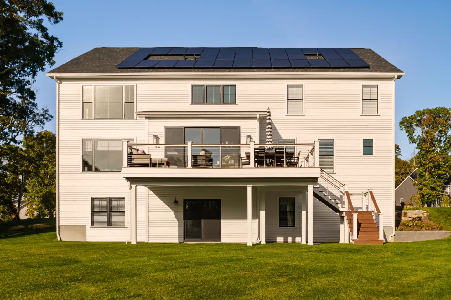 modern-house-with-solar-panels-and-under-deck-with-outdoor-furniture-in-lincoln-ne