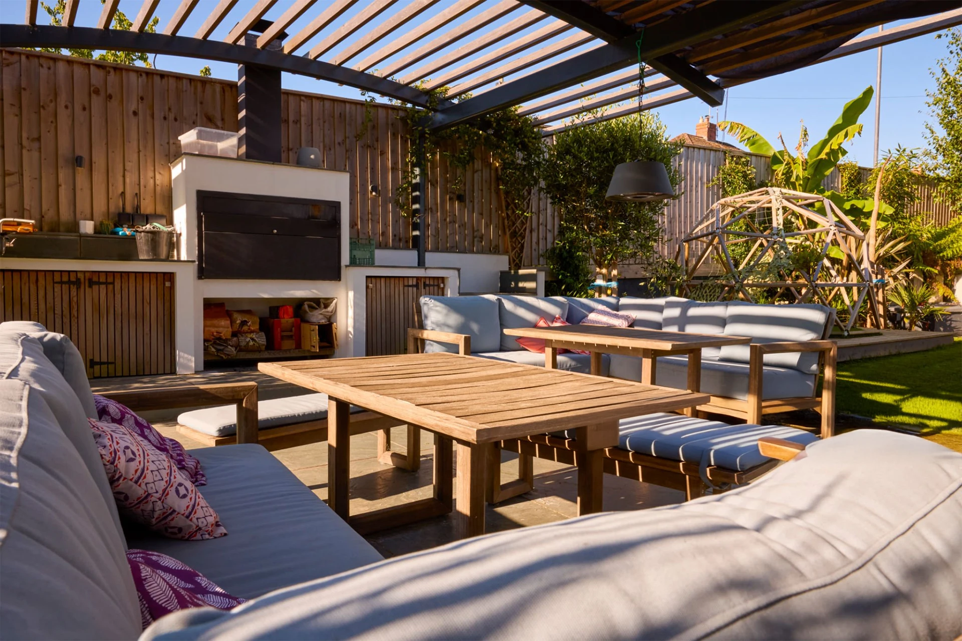 outdoor-living-area-and-garden-of-modern-house-with-fireplace-and-wooden-fence-in-lincoln-ne