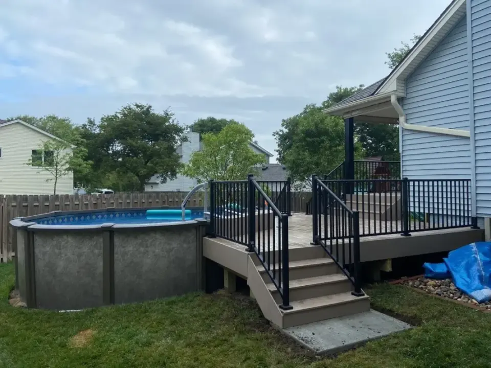 raised-multi-level-deck-with-black-metal-railing-and-pool-in-lincoln-ne