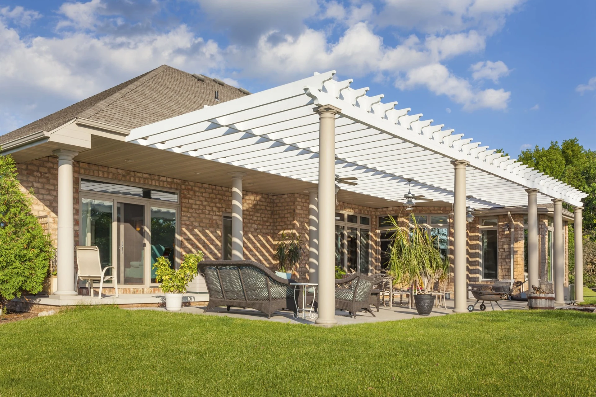 scenic-brick-house-with-large-patio-and-white-pergola-in-lincoln-ne