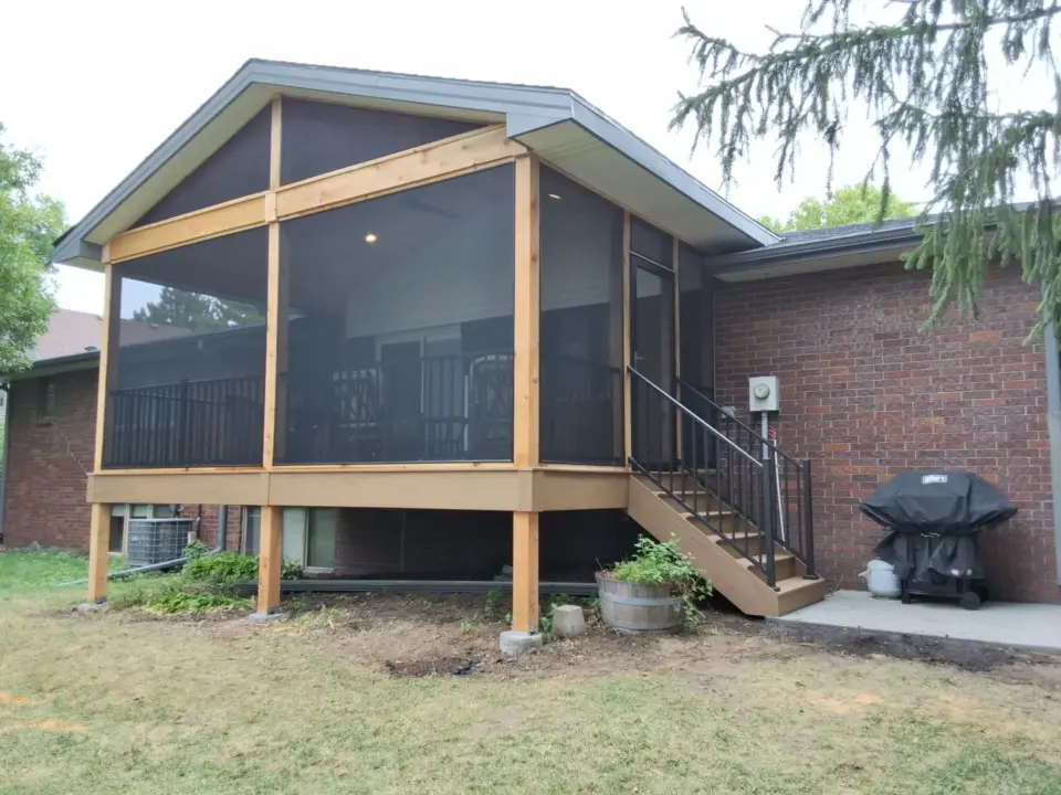 screened-in-porch-in-elevated-custom-residential-deck-with-black-metal-railing-in-lincoln-ne