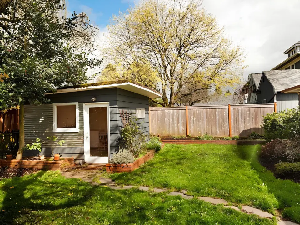 small-gray-shed-with-white-framed-and-wooden-wall-fence-in-lincoln-ne