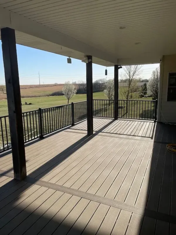 sun-kissed-elevated-residential-deck-with-black-metal-railing-and-overlooking-view-in-lincoln-ne